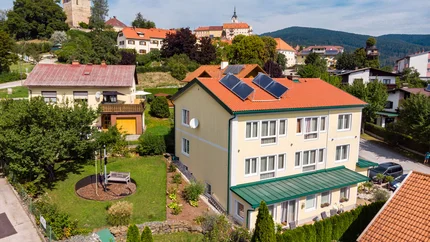 Bed&Breakfast Mittelkärnten © Bed and Breakfast Mittelkärnten Dorf mit Häusern, Solarpanelen und Burgturm im Hintergrund bei klarem Himmel